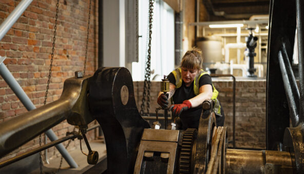 Museum technician with engine in Power Hall