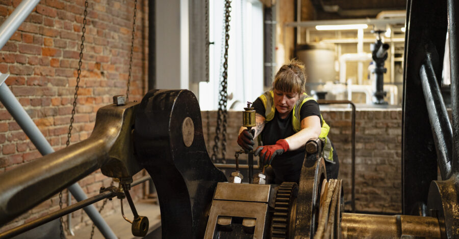 Museum technician with engine in Power Hall