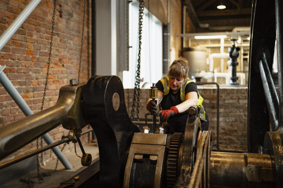 Museum technician with engine in Power Hall