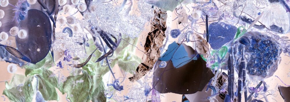 Different materials layered over eachother, collaged and layered in shades of deep purple and light green, watery blues.