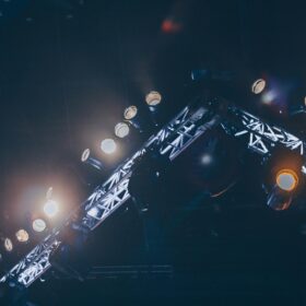 A lighting rig is switched on above a stage.