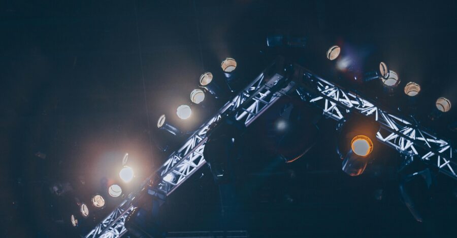 A lighting rig is switched on above a stage.