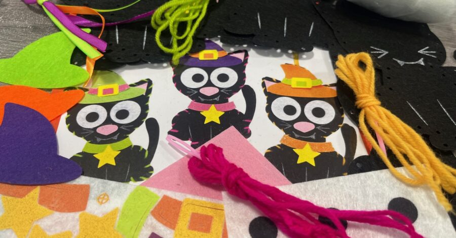 A variety of green pink and orange thread alongside different coloured felt.