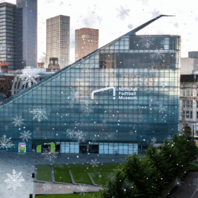 The glassy triangular exterior of the National Football Museum building.