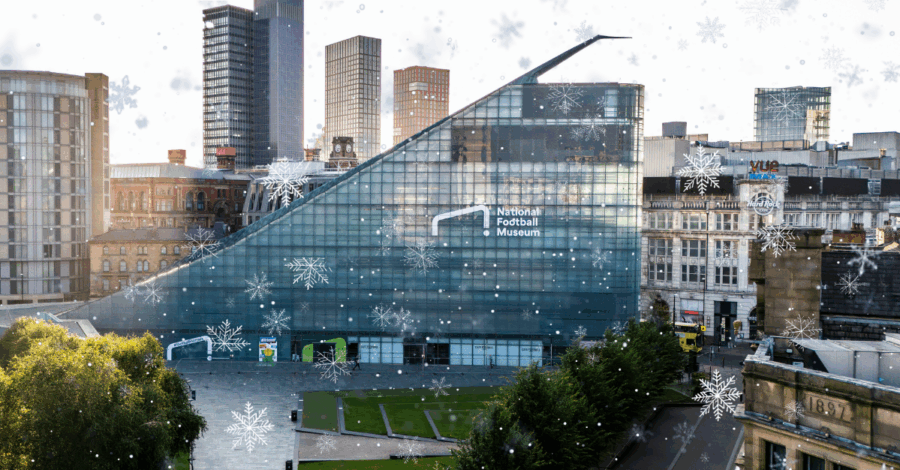 The glassy triangular exterior of the National Football Museum building.