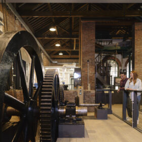 A groups of adults stood in the Power Hall at the Science and Industry Museum.