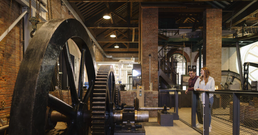 A groups of adults stood in the Power Hall at the Science and Industry Museum.