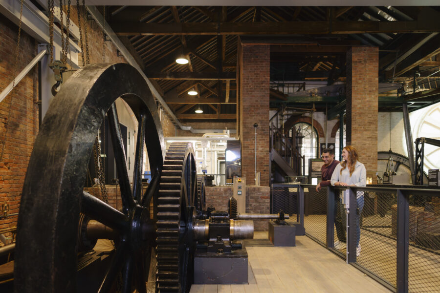 A groups of adults stood in the Power Hall at the Science and Industry Museum.
