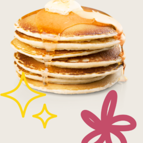 A pile of pancakes with a knob of butter and some syrup poured over the top.