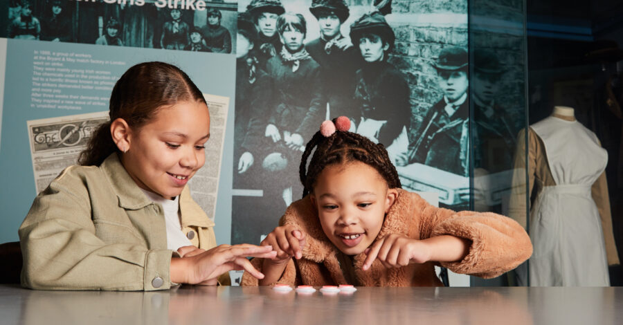 Visitors playing Match Girls' Strike game at People's History Museum.