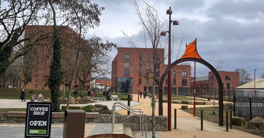 A picture of Ancoats Green with paths, buildings and green spaces.