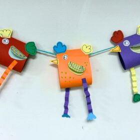 A chain of bunting with paper-crafted chickens for flags.