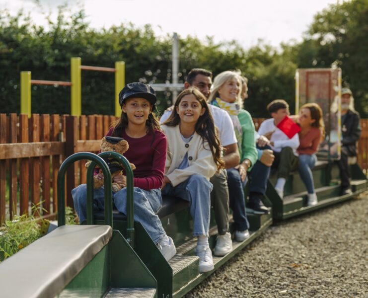 Family enjoying a mini train ride similar to the one popping up at SIM