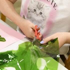 Child in cat t-shirt doing crafts