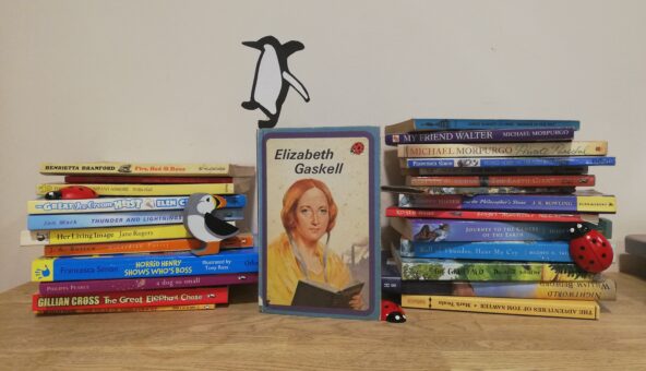 A stack of children's books with penguins, ladybirds and puffins figures.