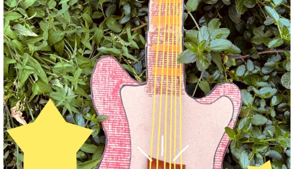 A guitar crafted from cardboard.