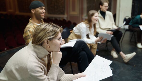 A group of people sitting with their scripts.