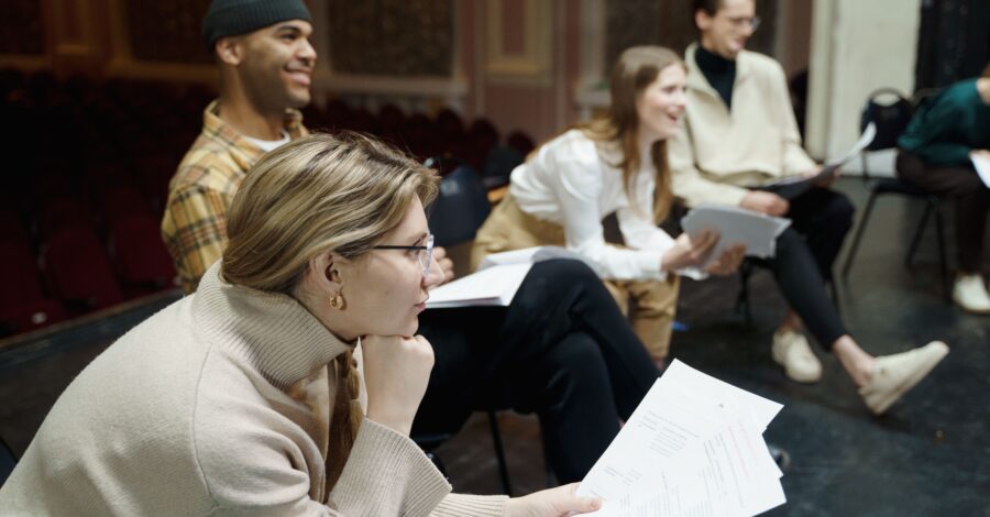 A group of people sitting with their scripts.