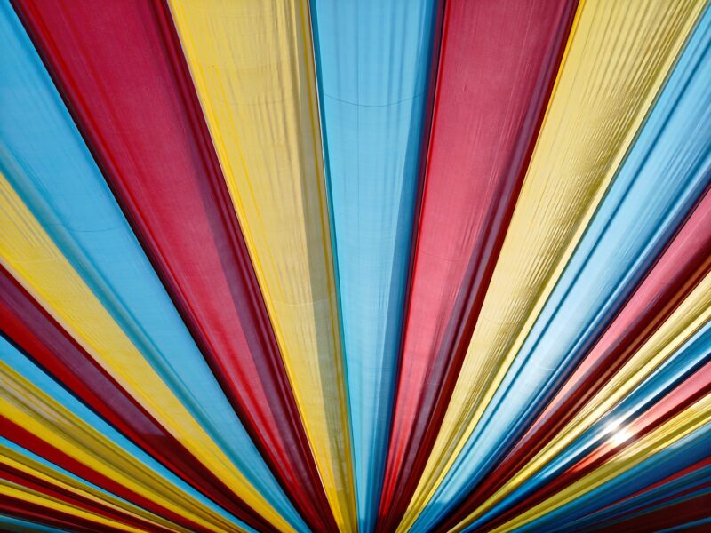 A colourful striped canopy in red, yellow and blue.